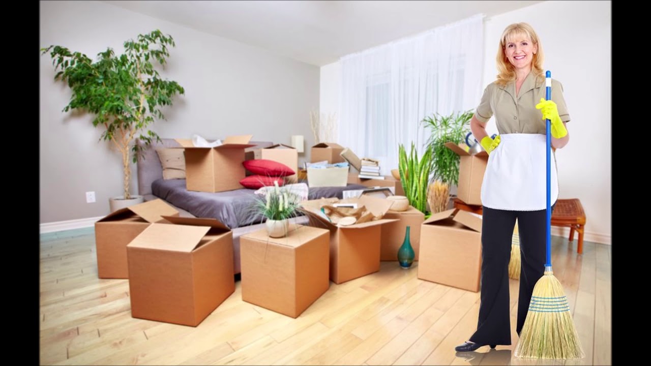 Professional cleaner organizing and sweeping a home with moving boxes — Move-In & Move-Out Cleaning Services in Fuquay Varina, NC.
