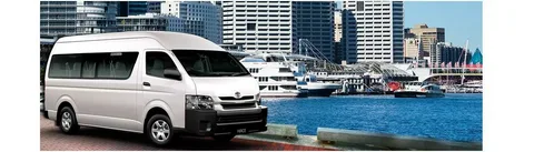 A minibus in front of buildings