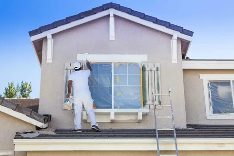A Painter is painting the house